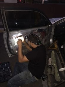 Man repairing door locks on Honda